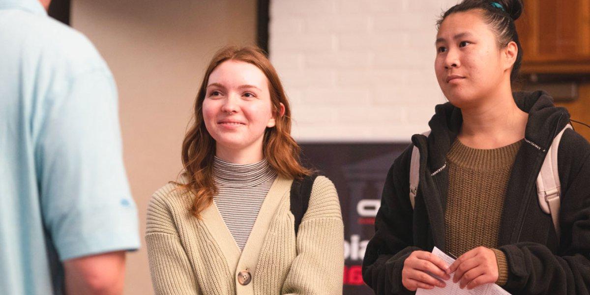 two saint mary's students speaking with recruiter